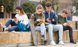 © JackF - Teens using phones outdoors, concept of youth obsession with social networks