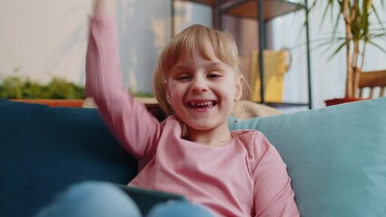 caucasian worried excited little teen child girl enthusiastically playing racing video online games 