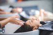 © chokniti - hairdresser washing client's hair at salon. happy young women customer relax and comfortable while washing hair, luxury hair spa by professional hairstylist