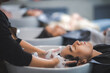 © chokniti - hairdresser washing client's hair at salon. happy young women customer relax and comfortable while washing hair, luxury hair spa by professional hairstylist