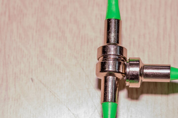 Closeup of three magnetic tipped darts on scratched tabletop.