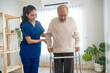 Asian senior elderly man patient doing physical therapy with caregiver