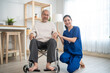 Portrait of Asian caregiver nurse take care senior male on wheelchair. 