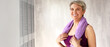 © Pixel-Shot - Portrait of sporty mature woman with towel at home