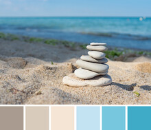 Color Palette Swatches Of Flat Pebbles Pyramid Stack On Beige Brown Sand On Sunny Beach And Turquoise Blue Blurred Sea Water Background. Pastel Trendy Combination, Colorful Inspiration From Nature.