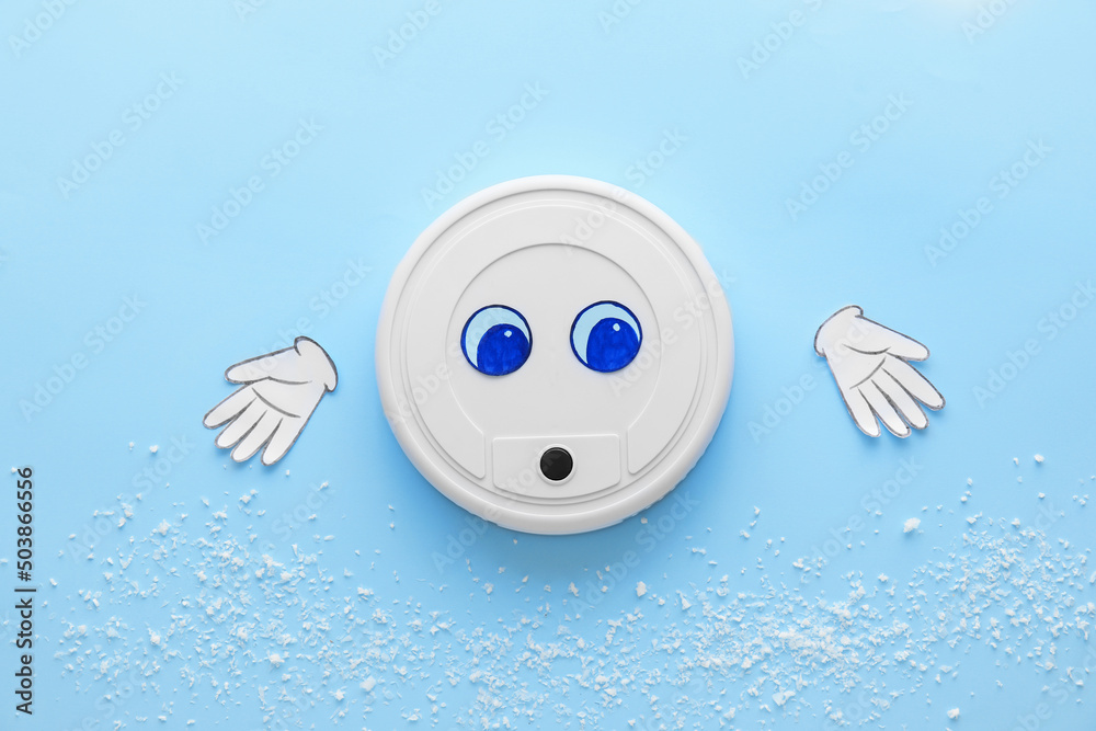 Modern robot vacuum cleaner with drawn eyes and paper hands on blue background