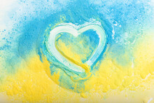Ukrainian Flag In The Shape Of A Heart, The Concept Of Peace In Ukraine. Powder Paint Holi.