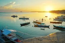 Beautiful Colorful Sunset On The Seashore With Fishing Boats. Philippines, Siargao Island.