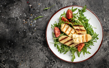 Wall Mural - halloumi cheese salad with arugula and tomatoes. ketogenic paleo diet. Delicious breakfast or snack, Clean eating, dieting, vegan food concept. top view