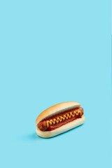 Classic hot dog with wurst, ketchup and mustard on blue background. Menu for restaurant