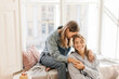 © Look! - Young caucasian girl with closed eyes and her mother are resting together at window on sunny warm day. Blondes wear shirts and jeans. Concept of relationships and sharing time.
