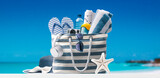 Fototapeta Kawa jest smaczna - Beach bag with accessories and tropical beach
