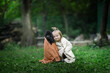 © natalialeb - Cute baby toddler in towels with pet. Child and black poodle in a towel after swimming in the backyard in summer