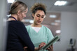 © ReeldealHD images - Female surgeon discussing patient treatment using a digital tablet to review x-ray