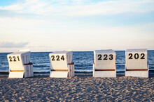 Four Beach Chairs On The Sandy Beach At The Baltic Sea.
