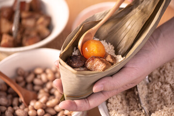 Making zongzi food - preparing and wrapping Chinese rice dumpling.