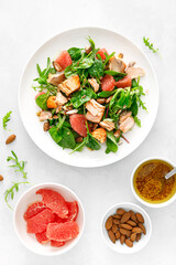 Wall Mural - Grilled salmon salad with grapefruit, almonds and salad mix. Top view