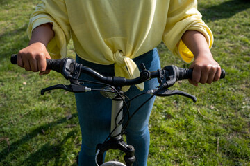 Wall Mural - Girl with hands on bicycle handles