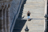 Fototapeta Na drzwi - people walking by stone stairs with backpack