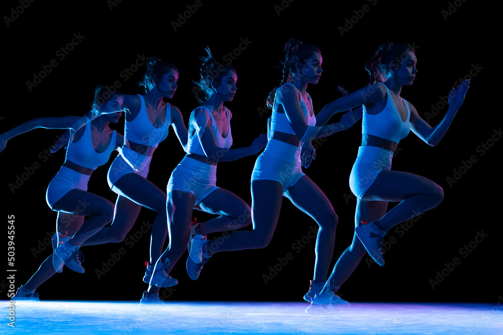 Development of movements. Professional female athlete, runner training isolated on dark background with stroboscope effect.