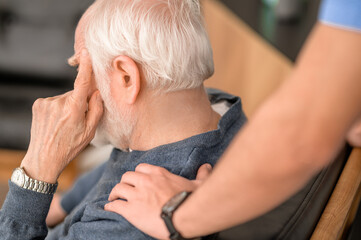 Wall Mural - Experienced in-home caretaker comforting an elderly person