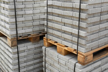 Stack Of Contemporary Stone Paving Slabs Pavers. Building Material On Pallet For Road Paving. Sidewalk Tile. Construction Site