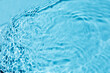 © Miha Creative - Liquid colored clear water surface texture with splashes bubbles.  Blue water waves in sunlight background.