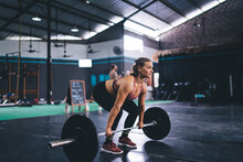 Young Female In Active Sportswear Pick Up Barbell Equipment During Weightlifting Training Practice In Gym Studio, Strong Fit Girl Have Deadlift Workout For Keeping Body Muscles In Tonus - Stamina