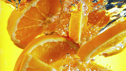 Wall Mural - Close up of orange slices in water.