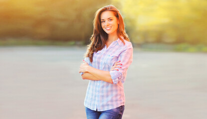 Wall Mural - Summer image of beautiful smiling young woman in the city