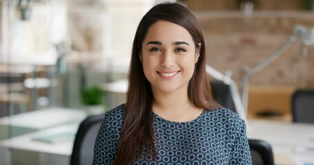 Poster - Focused professional businesswoman sitting in her office smiling. Powerful, happy young businesswoman sitting in her office smiling. Content businesswoman sitting in her office