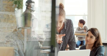 Aufkleber - A group of diverse businesspeople talking and brainstorming during a meeting using a laptop. Young businesswoman talking to staff team collaborating with colleagues. Coworkers in a business meeting