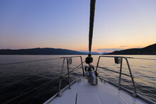 Bow Of Sailing Yacht, View From The Sailboat At Sunset