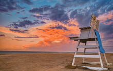 Sunset On Beach With Lifeguard Chair Room For Text