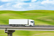 LKW Truck fährt über Brücke in schöner Landschaft