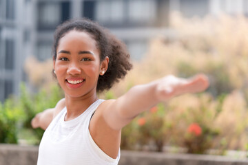 Young black woman workout in the morning with happiness and smiling face, doing the exercise for dieting to control her weight, calories under training program and eating fresh nutrition for healthy.