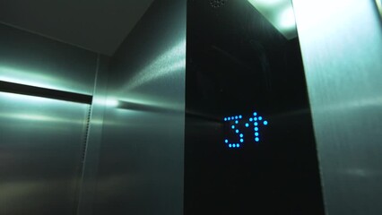 Close-up digital display in the elevator shows the rise to the 4th floor. Modern design and technology