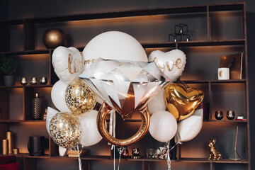 Bridal air balloons against book shelves.