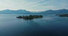 Beautiful 4k Aerial Drone Shot Of Small Island Fraueninsel Surrounded By Blue Lake Chiemsee In Gstadt, Chiemgau, Bavaria With Bavarian And Austrian Alps In Background.
