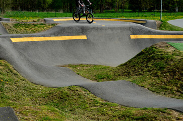 Sticker - bike path in the car park Pumping (moving up and down) is used instead of pedaling and bouncing to move bicycles, scooters, skateboards and inline skates along the modular pumptrack track