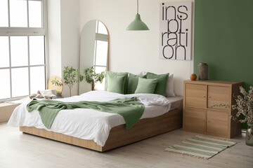 interior of stylish room with big bed and mirror