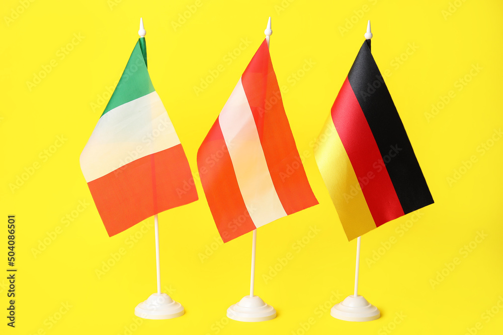 Flags of Italy, Austria and Germany on yellow background