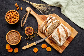 Wall Mural - Loaf with dried fruits and nuts. Healthy homemade bread top view