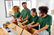 © Syda Productions - charity, donation and volunteering concept - international group of happy smiling volunteers packing food in boxes according to list on clipboard at distribution or refugee assistance center