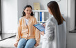 © Syda Productions - medicine, healthcare and people concept - female doctor with clipboard talking to woman patient at hospital
