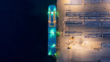 Fototapeta Kawa jest smaczna - New car lined up in the port for import export around the world, Automobile and automotive roro carrier boat vessel terminal, Aerial view rows of new car at night waiting to be dispatch and shipped.