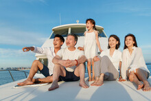 Happy Family Aboard A Yacht Out To Sea