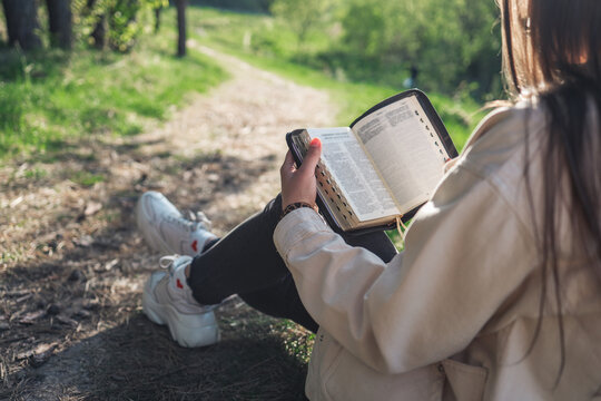 Girl with the Bible in nature. beautiful christian picture