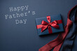 Blue gift box and neckties on dark blue background. Father's day card.