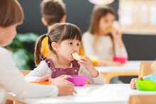 Children Eating A Fruit Snack In A Kindergarten 